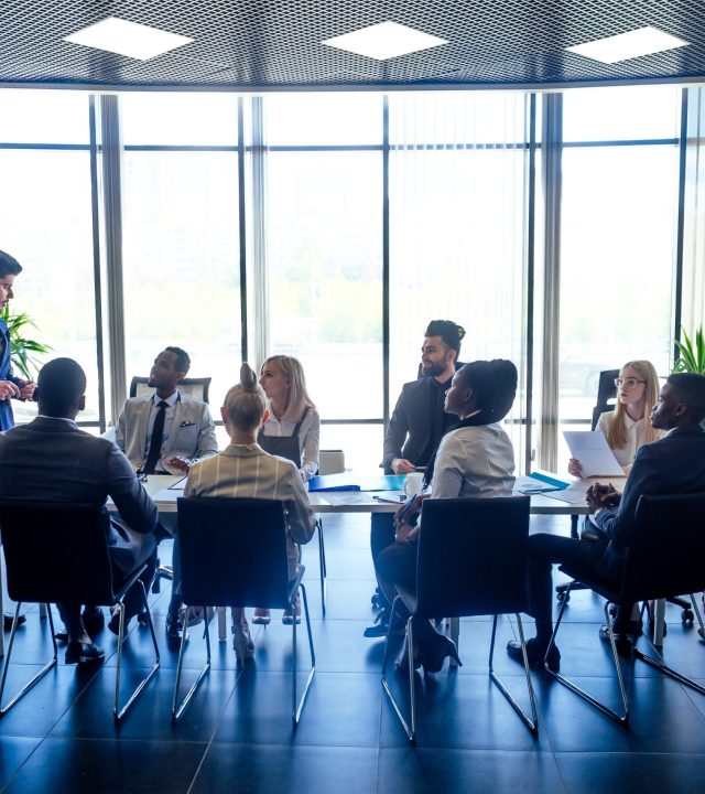 a group of successful afro americans, europeans ,arabic and korean businessman and businesswoman working in the office with large glass windows